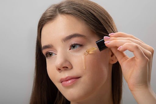 Woman applying an antioxidant serum for skin using a dropper pipette