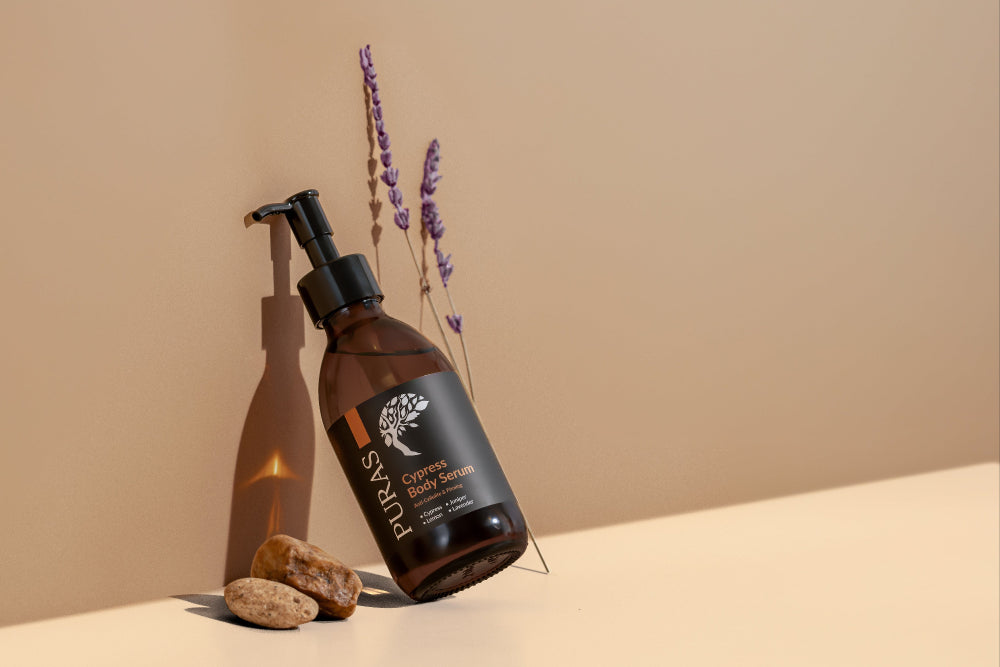 Puras cypress body serum on a beige surface with lavender flowers