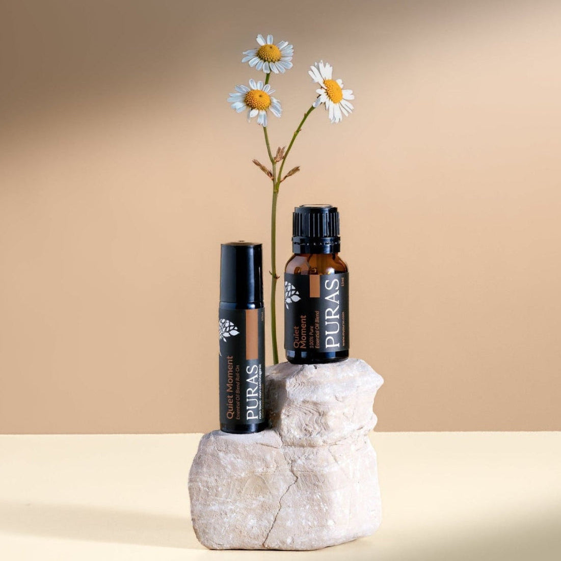 Quiet monment essential oil and roll on on white stone