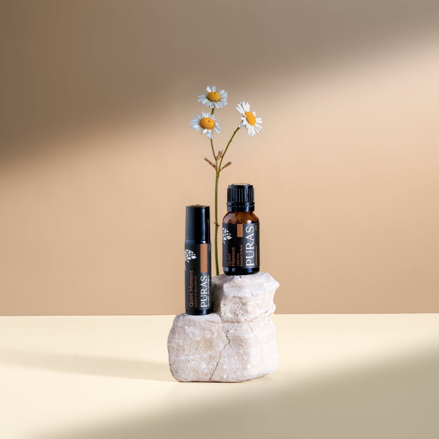 Quiet monment essential oil and roll on on white stone