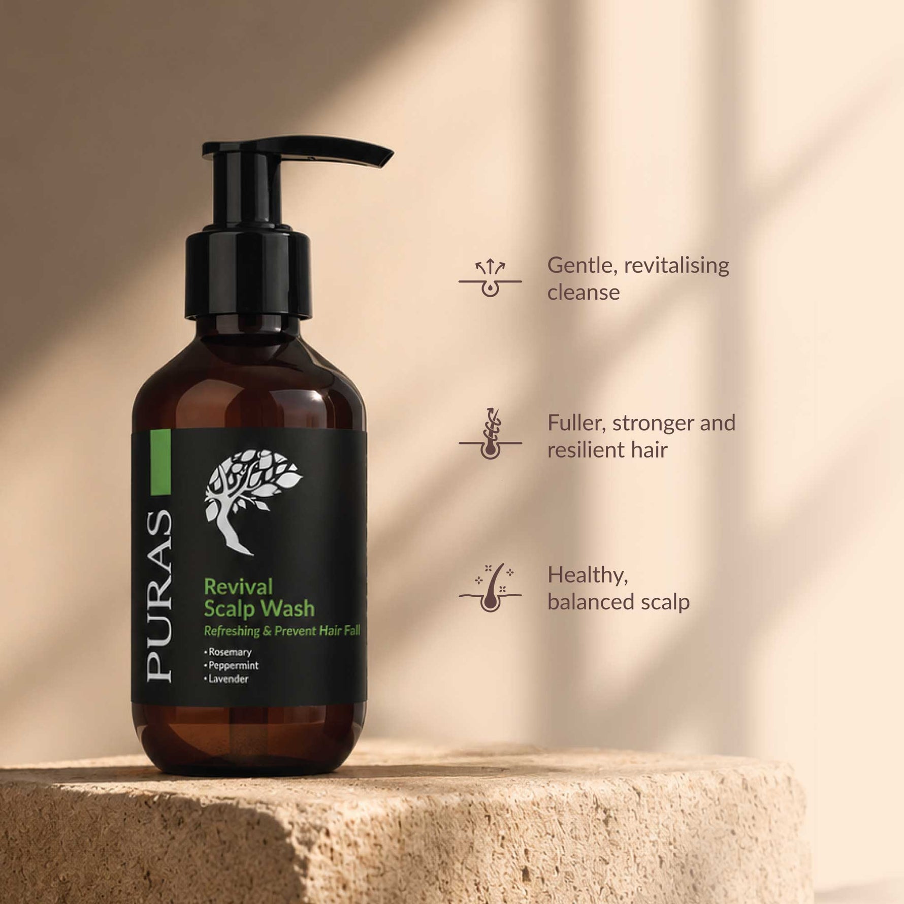 PURAS Revival Scalp Wash in an amber glass bottle with a black pump dispenser, displayed on a stone pedestal against a warm beige background with soft shadows. To the right, three key benefits are listed with simple icons: Gentle, revitalising cleanse; Fuller, stronger and resilient hair; Healthy, balanced scalp.