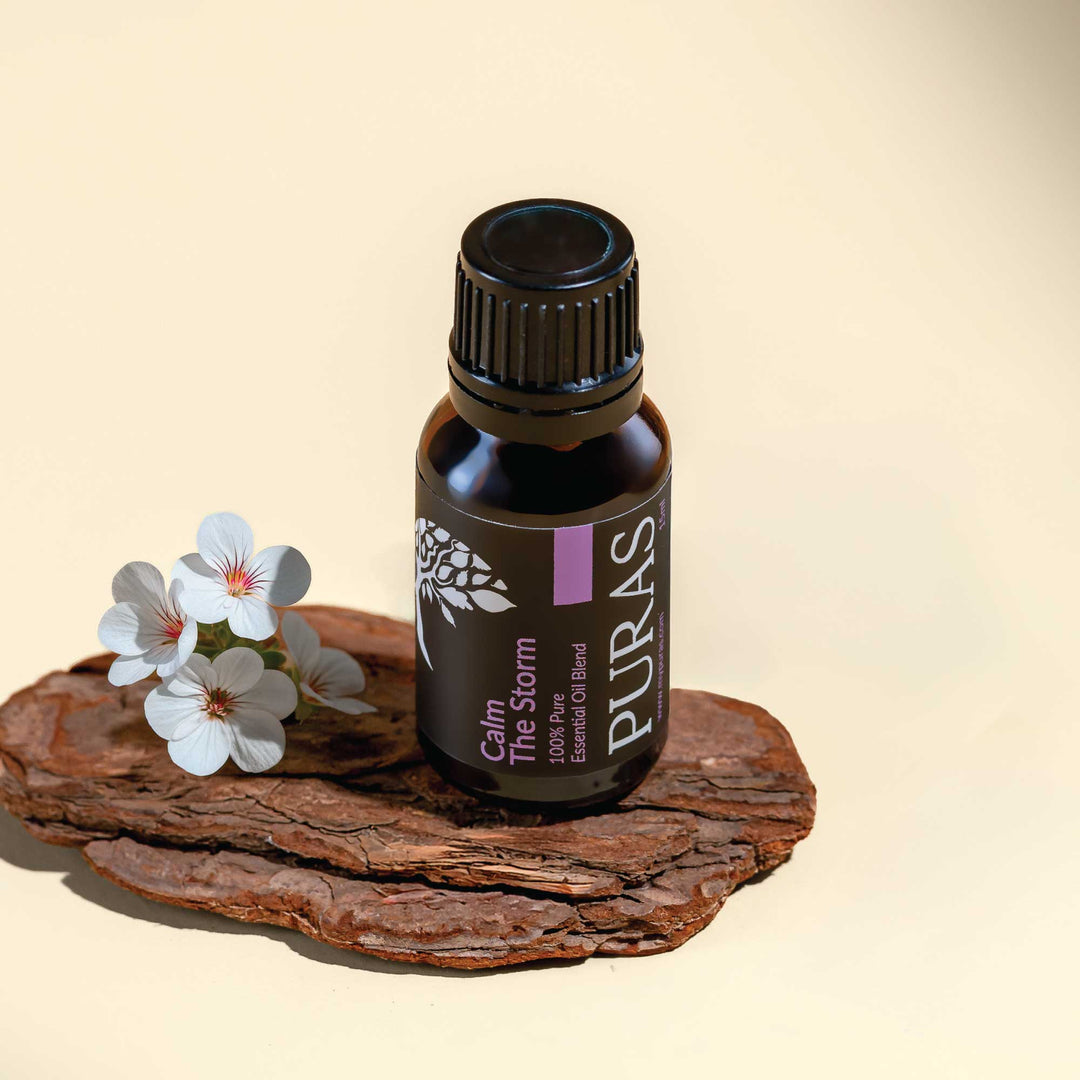 Puras essential oil bottle on a natural surface with flowers