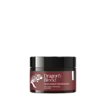 Jar of 'Dragon's Blood' antioxidant moisturizer on a plain background