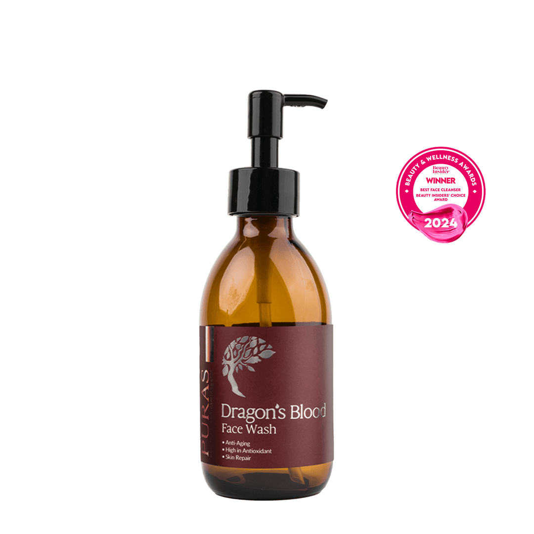 maroon bottle of Dragon's Blood Face Wash with a pump on a plain background