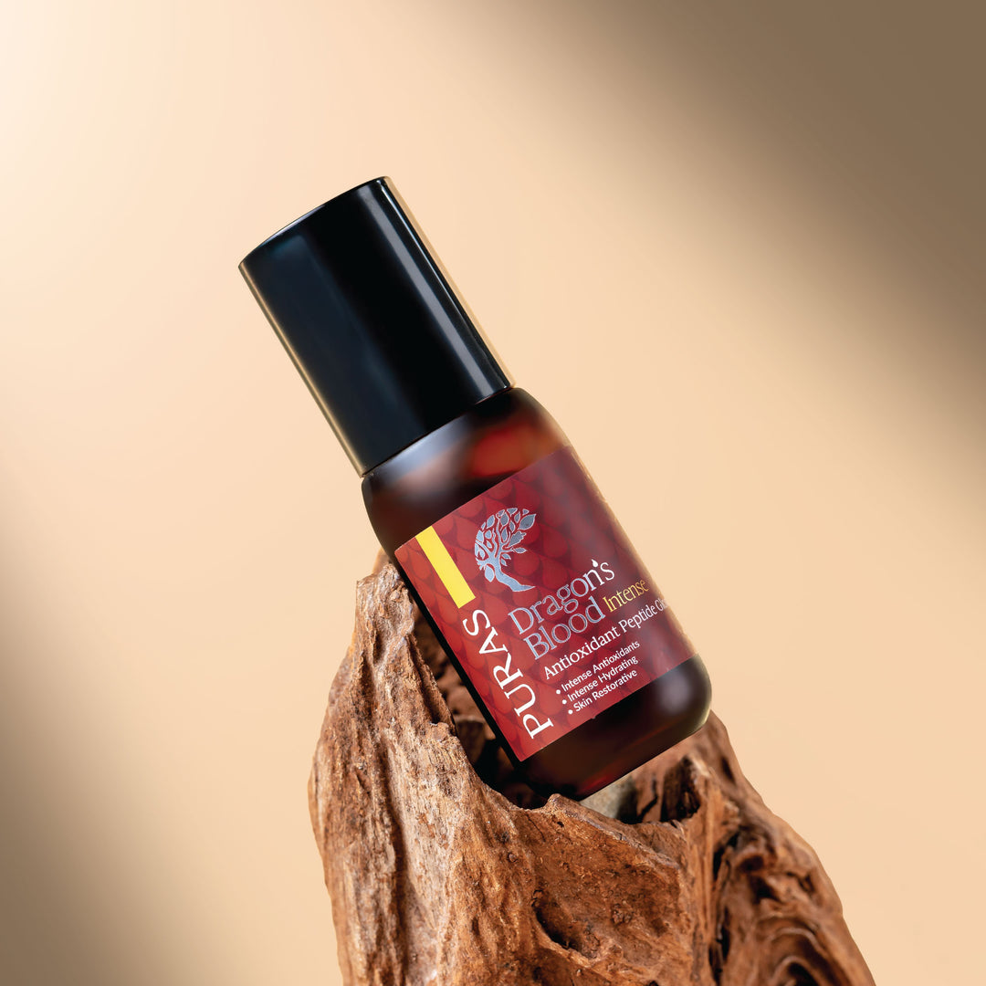 Puras Dragon's Blood Intense Peptide Glow Serum bottle on a wooden block with a beige background