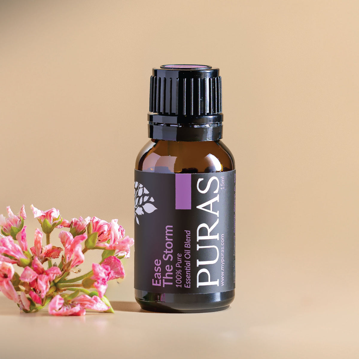 Puras Ease The Stom essential oil blend bottle with pink flowers on a beige background