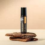 Puras "Gentle Horizon" essential oil roll-on bottle on a wooden surface with a beige background