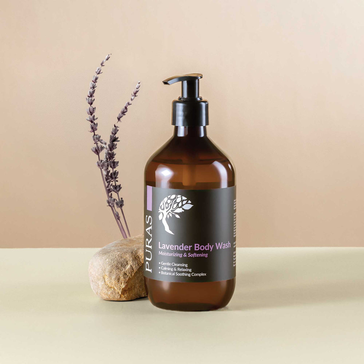 Brown bottle of PURAS Lavender Body Wash with lavender plant and rock on beige background
