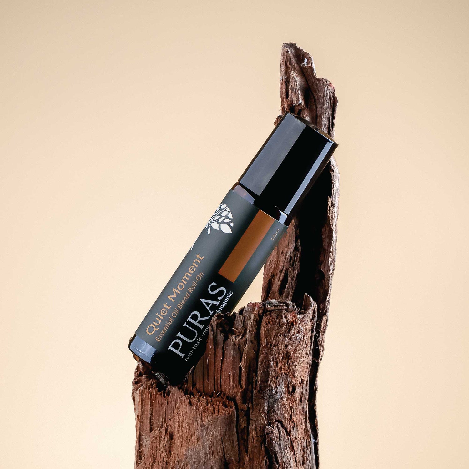 Puras "Quiet Moment" roll-on on a wooden background