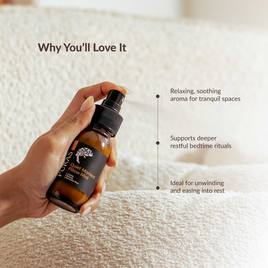 Hand holding a bottle of pillow spray with text on a soft fabric background