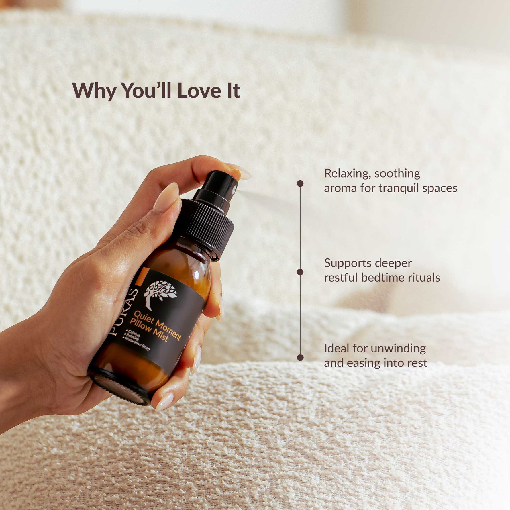 Hand holding a bottle of pillow spray with text on a soft fabric background