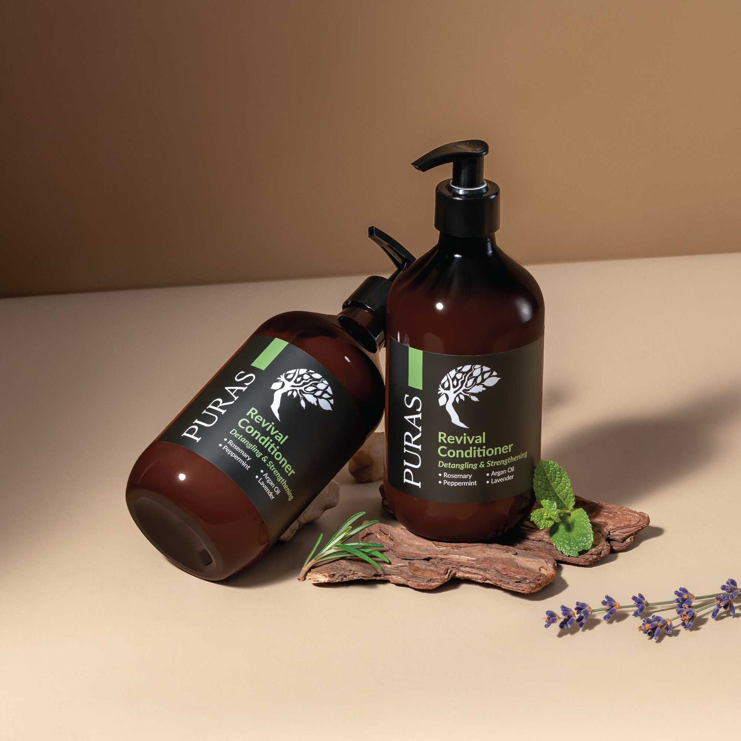 Two bottles of Puras Revival Conditioner on a beige surface with a brown background