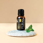 Puras "Super Clear Up" essential oil bottle on a stone with a leaf on a beige background