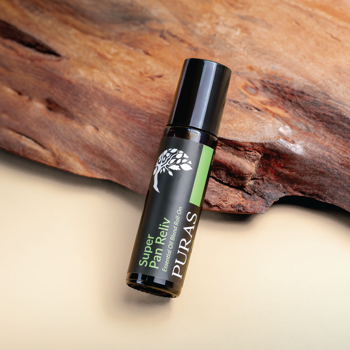 Puras Super Pan Reliv Essential Oil Roll-On bottle on a wooden background