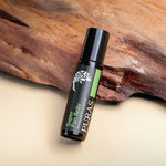 Puras Super Pan Reliv Essential Oil Roll-On bottle on a wooden background